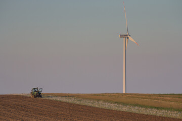 Agriculture machinery in action a tractor plows a field on a bright day © Bagatela