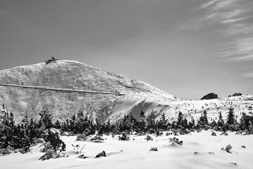 People on the trail and a tourist shelter on the top of Sniezka in the Giant Mountains