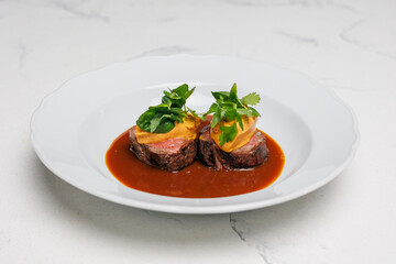 Veal medallions with herbs and sauce