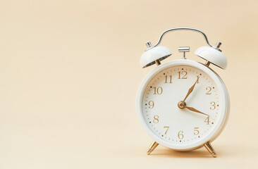 White alarm clock on a colored background.