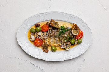 Fish steak with seafood and shellfish on a large plate.