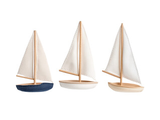Obraz premium Three decorative sailboats on a white isolated background, perfect for nautical-themed decor.