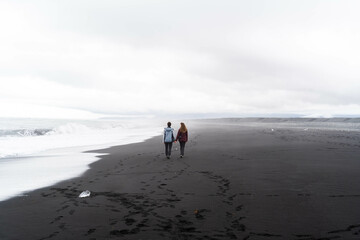 A couple in love holding hands by the sea