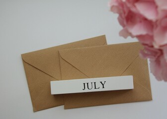 Summer month July and brown envelopes