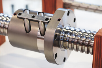 Close up of industrial metal screw shaft as part of screw transmission. Industrial background concept