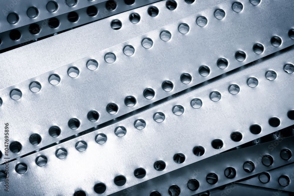 Aufkleber a series of metal strips with holes in them. the holes are evenly spaced and the strips are of varyi