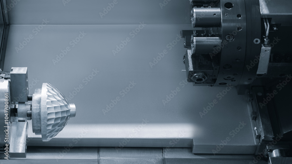 Poster a cnc machine is cutting a piece of metal. the machine is large and has many parts. the metal is bei