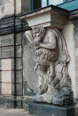 Fototapeta premium Sculpture, ancient statue of a demon, devil made of stone in a European city.