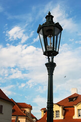 Photo of an old lantern with a lamp on the street in the capital of the Czech Republic, Prague.