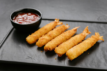 Golden fried shrimp sticks with crispy breading and dipping sauce. Perfect for appetizers or snacks