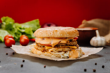 Double-layered chicken burger with melted cheese and fresh toppings