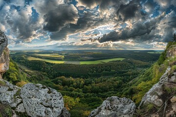 A scenic view of a valley from a rocky outcropping, ideal for use in travel or adventure photography