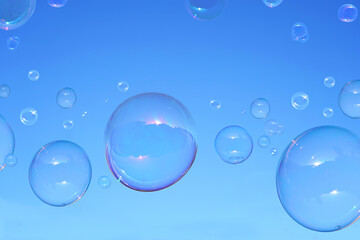Soap bubbles on blue sky .    