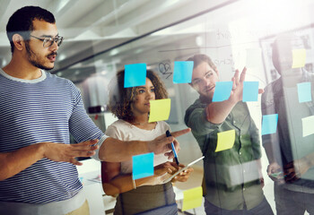 Creative, people and sticky notes on glass for strategy, timeline and design process in office...