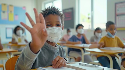 Young student in a classroom wearing a mask for hygiene and protection during the pandemic,...