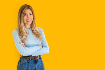 Portrait of a young Caucasian woman with pleasant smile and crossed arms isolated