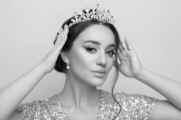 Black-and-white portrait of beautiful young woman with luxury crown