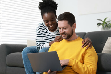 International relationships. Lovely couple spending time together at home