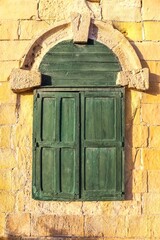 An old wooden blue door in a Mediterranean setting in a historic town in Italy.