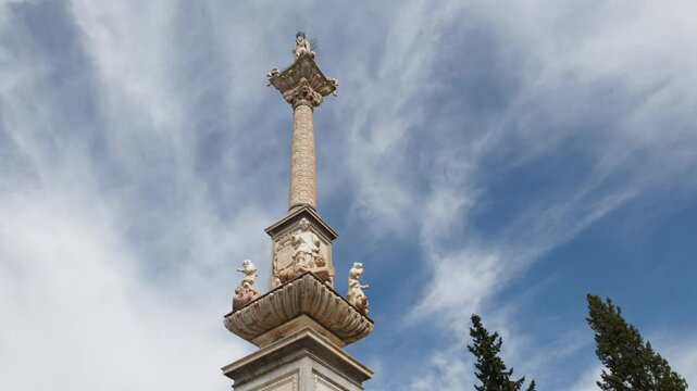 A Stunning Monument Stands Proudly Under a Beautiful Blue Sky with Dramatic Clouds