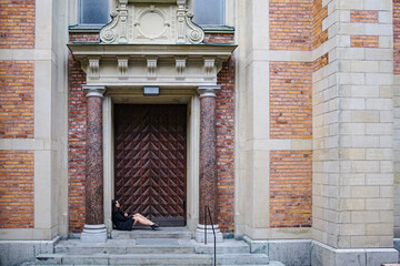 A woman sitting in front of a gate
