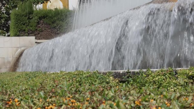 A Stunning Tranquil Waterfall with Water Flowing Gently Over Lush Greenery and Flora