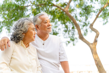 Happy Asian family senior couple enjoy outdoor lifestyle travel nature at the sea on summer beach holiday vacation. Healthy elderly husband and wife relaxing romance hug on tropical island at sunset. - Powered by Adobe