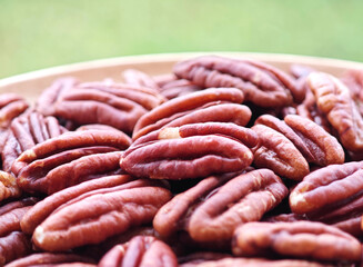 pecan nut   in bowl on background.
