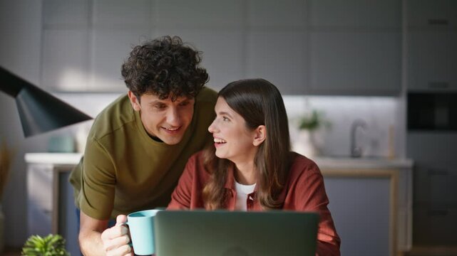 Amazed friends talking virtual call looking computer screen at kitchen closeup