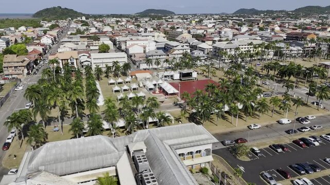 Drone orbits around north to east side of Place des Palmistes in Cayenne, French Guiana, France