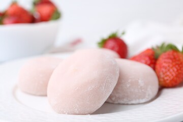 Delicious mochi and strawberries on plate, closeup