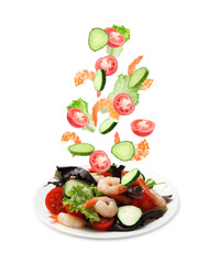 Shrimps and other ingredients falling onto plate on white background