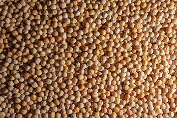 Uncooked Yellow Polished Peas Background. A Culinary Canvas of Dry Yellow Peas, Creating a Lively and Textured Background for Gourmet Cooking. Scattered Raw Polished Peas. Healthy Eating Ingredients