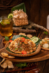 Tahu tek egg with chips or cracker, cucumber and petis sauce on aesthetic background. Tahu tek comes from Surabaya, an authentic Indonesian food.,
