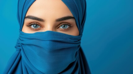 Naklejka premium A female doctor in a hijab and mask, skillfully balancing professionalism with cultural identity against a blue backdrop.