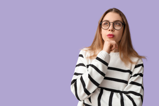 Thoughtful young woman trying to remember something on lilac background. Reminder concept
