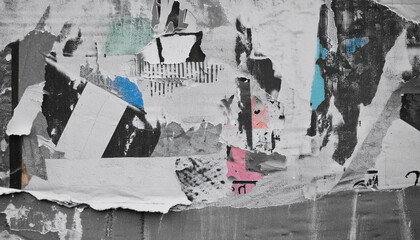 Fototapeta premium Torn paper poster, revealing the layers underneath, creating a vintage and gritty abstract texture