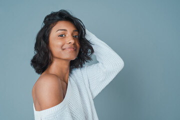 Portrait, hair care and Indian woman with beauty, texture and space on blue studio background....