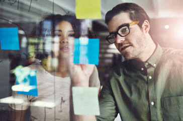 Businessman, writing and schedule with glass board for planning, brainstorming or tasks at office....