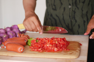 Chopping Fresh Tomatoes and Various Vegetables to Prepare Delicious Meals for Cooking