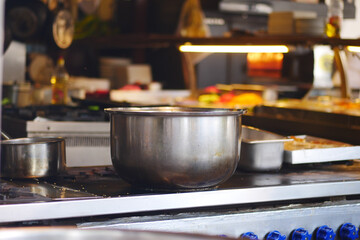 A shiny Stainless Steel Pot sits proudly on the Kitchen Counter in a bustling Professional Kitchen