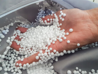 white styrofoam granules on cloth, usually used to fill bean bags or relaxing sofas.