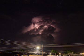 lightning in clouds at night over the city