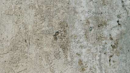 Close-up image of a weathered concrete wall with cracked and faded paint, showcasing a textured and aged surface.