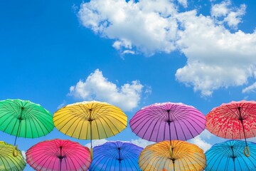 Obraz premium Colorful Umbrellas in a Bright Sky Procession