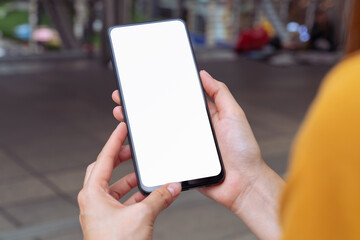 Hand holding smartphone mockup of blank screen, Take your screen to put on advertising.