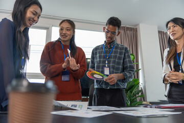 Group of software engineers design UX/UI for applications on smartphone/laptop