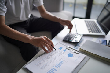 Man using calculator calculate finance and another hand holding pen