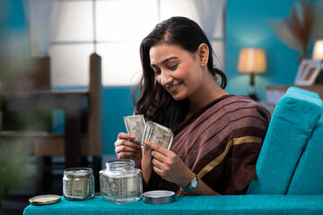 Goodwife Sitting On Sofa Counting Her Saving
