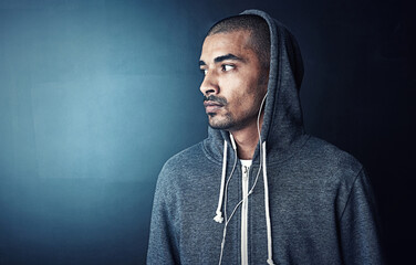 Fitness, thinking and man in gym with hoodie, earphones and mockup space at studio workout. Health,...